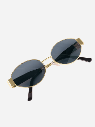 Sunglasses with gold frames and dark lenses on a white background