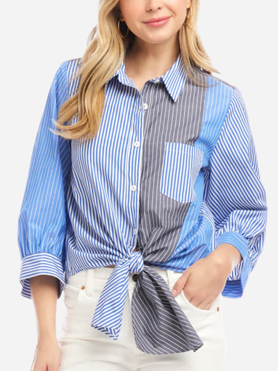 Woman wearing a blue and white striped shirt with a knot detail on a white background