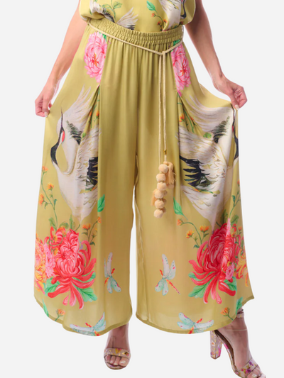 Yellow pants with floral and bird designs on a white background