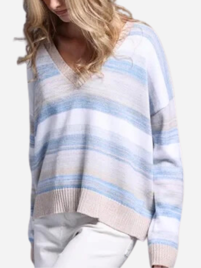 Woman in a blue and brown striped v-neck sweater