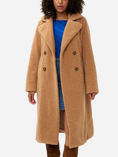 Person wearing a long brown coat on a white background