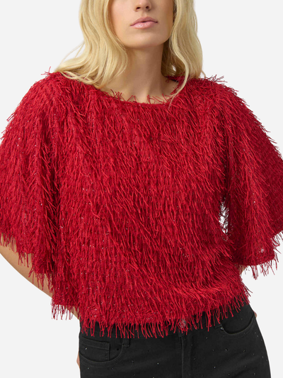 Red textured sweater worn by a woman on a white background