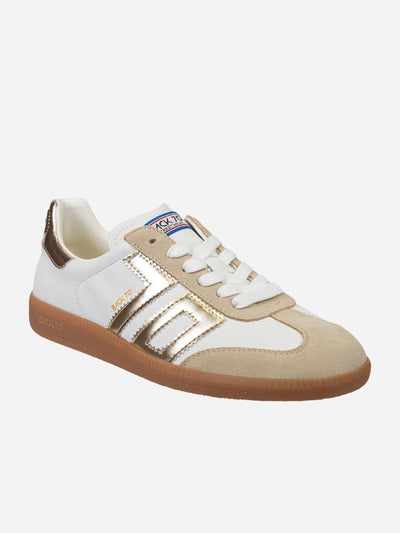 Beige and white sneaker with metallic accents on a white background