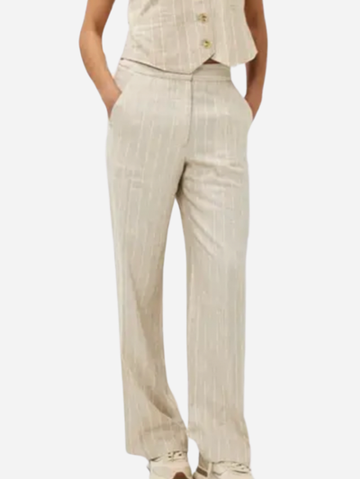 woman in brown and white striped linen pants