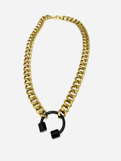 Gold chain necklace with black lock pendants on a white background
